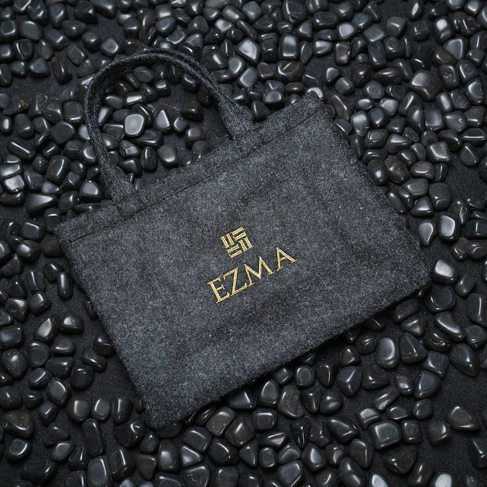 Dark gray pouch with 'EZMA' logo on a textured black surface